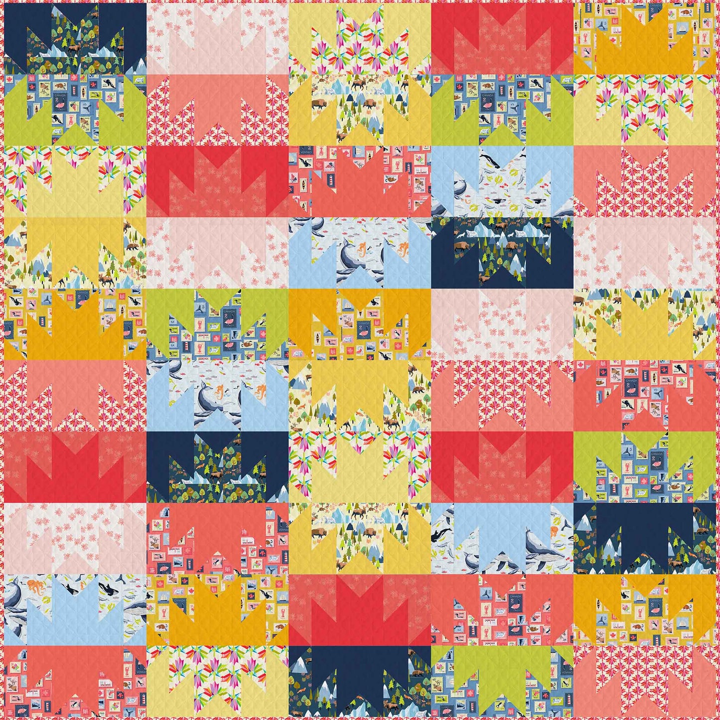 colourful quilt in reds, yellows and blues of squares with mountain shapes in solids and prints