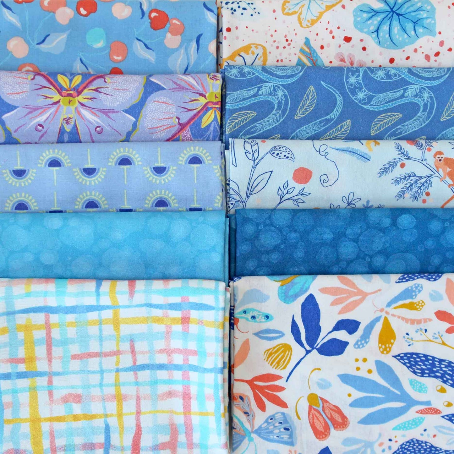 Collection of blue fabric swatches with different patterns.