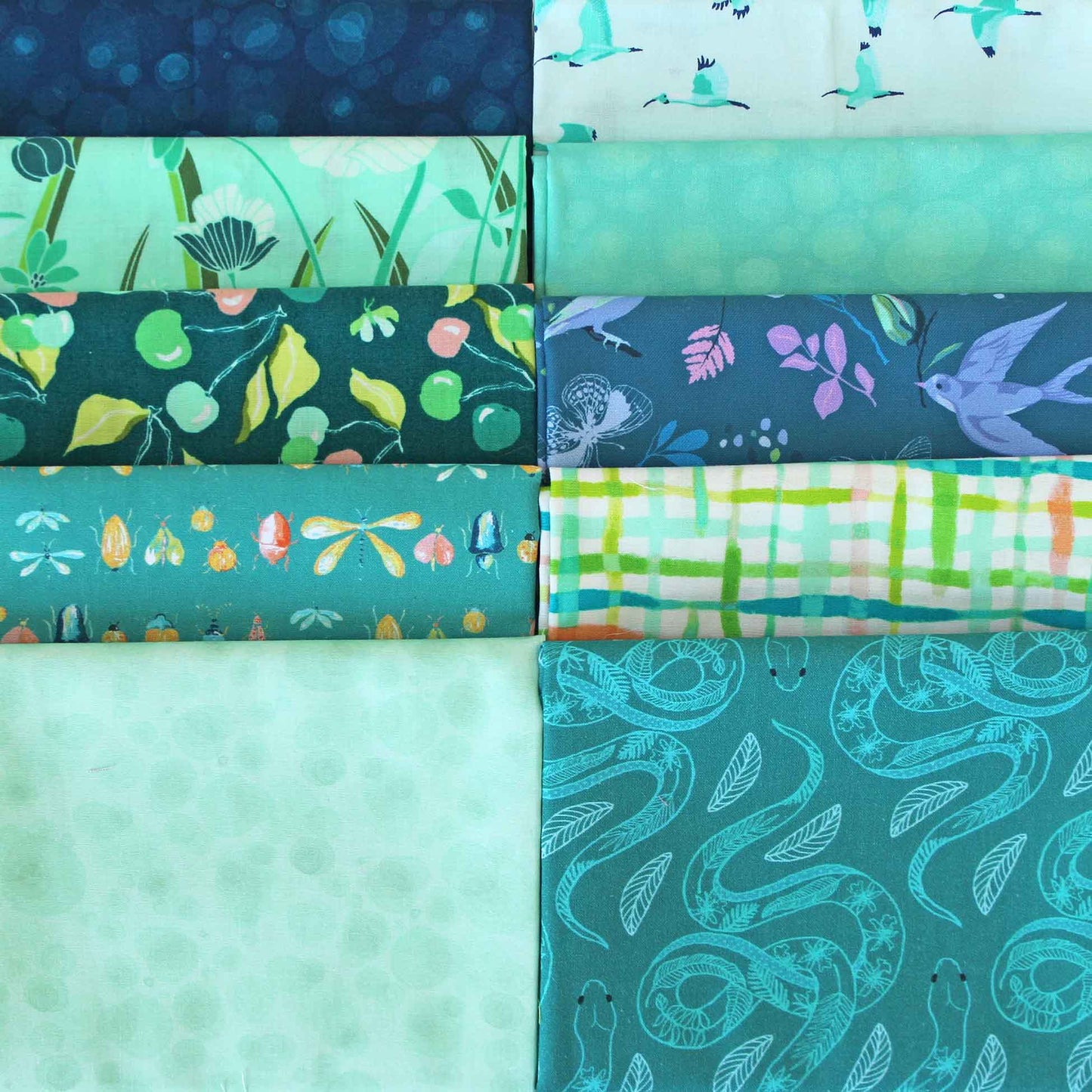 Collection of teal fabric swatches with various patterns