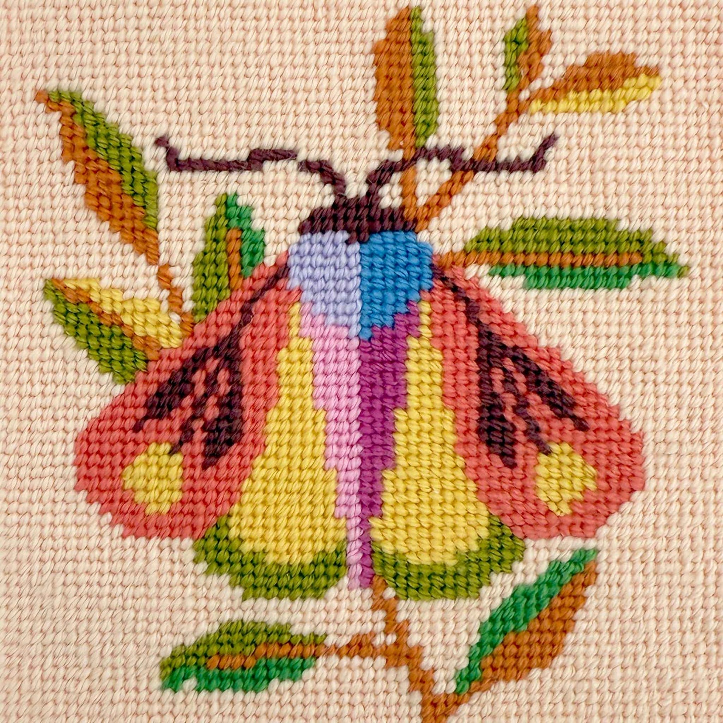 needlepoint of a modern illustrated moth in corals, blue and greens on a soft pink ground