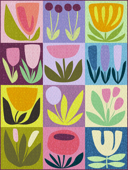 a 12-block appliqué quilt of bold illustrated flowers in blues, pinks, purples and greens