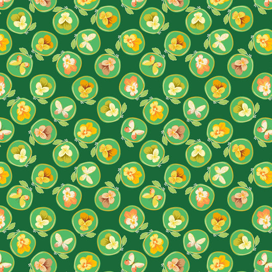 little illustrated pansies in yellows, cream and coral, each within a ring with a leaf on a dark green ground, printed on fabric