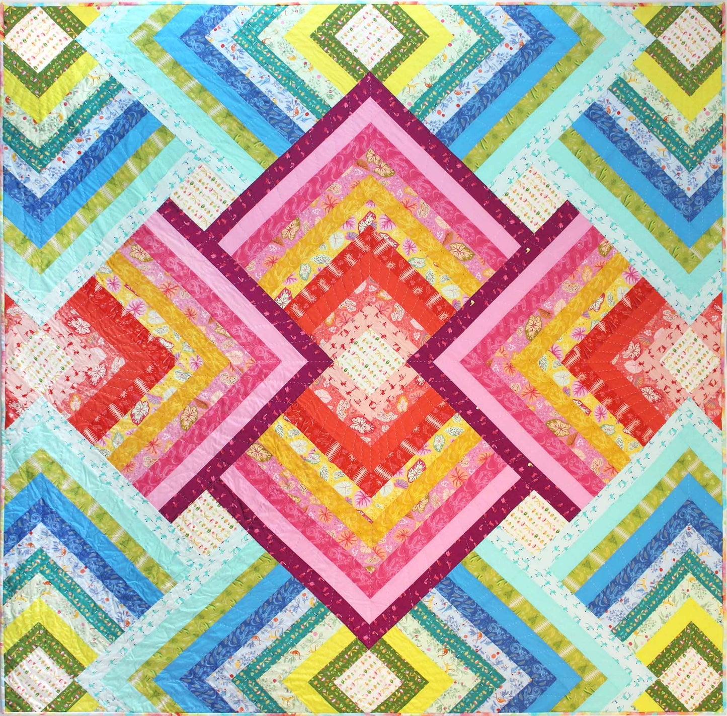 bold quilt of radiating squares in pinks and blues