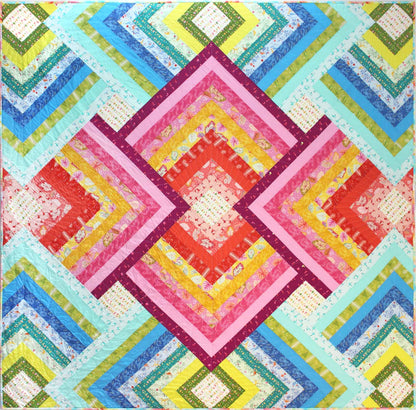 bold quilt of radiating squares in pinks and blues