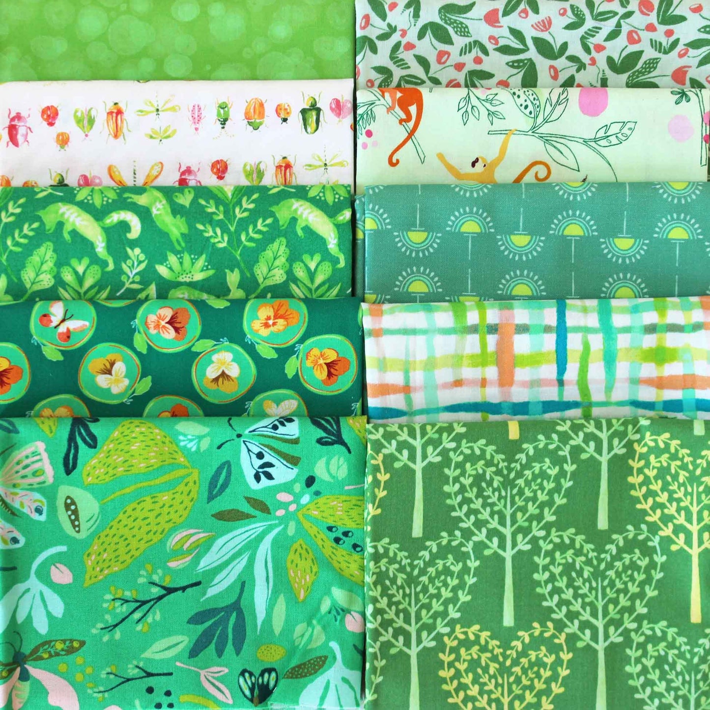 Collection of green-themed fabric swatches with various patterns.