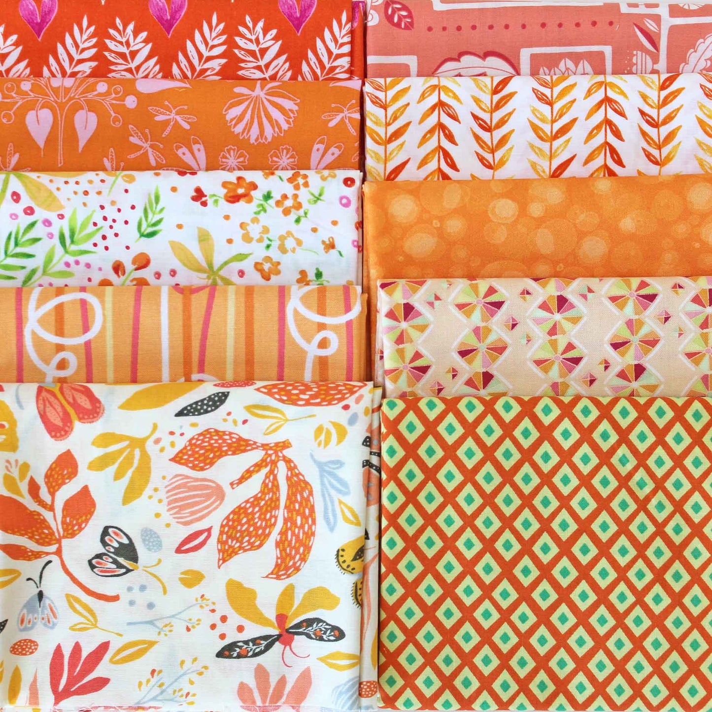 Collection of orange fabric swatches with various patterns.