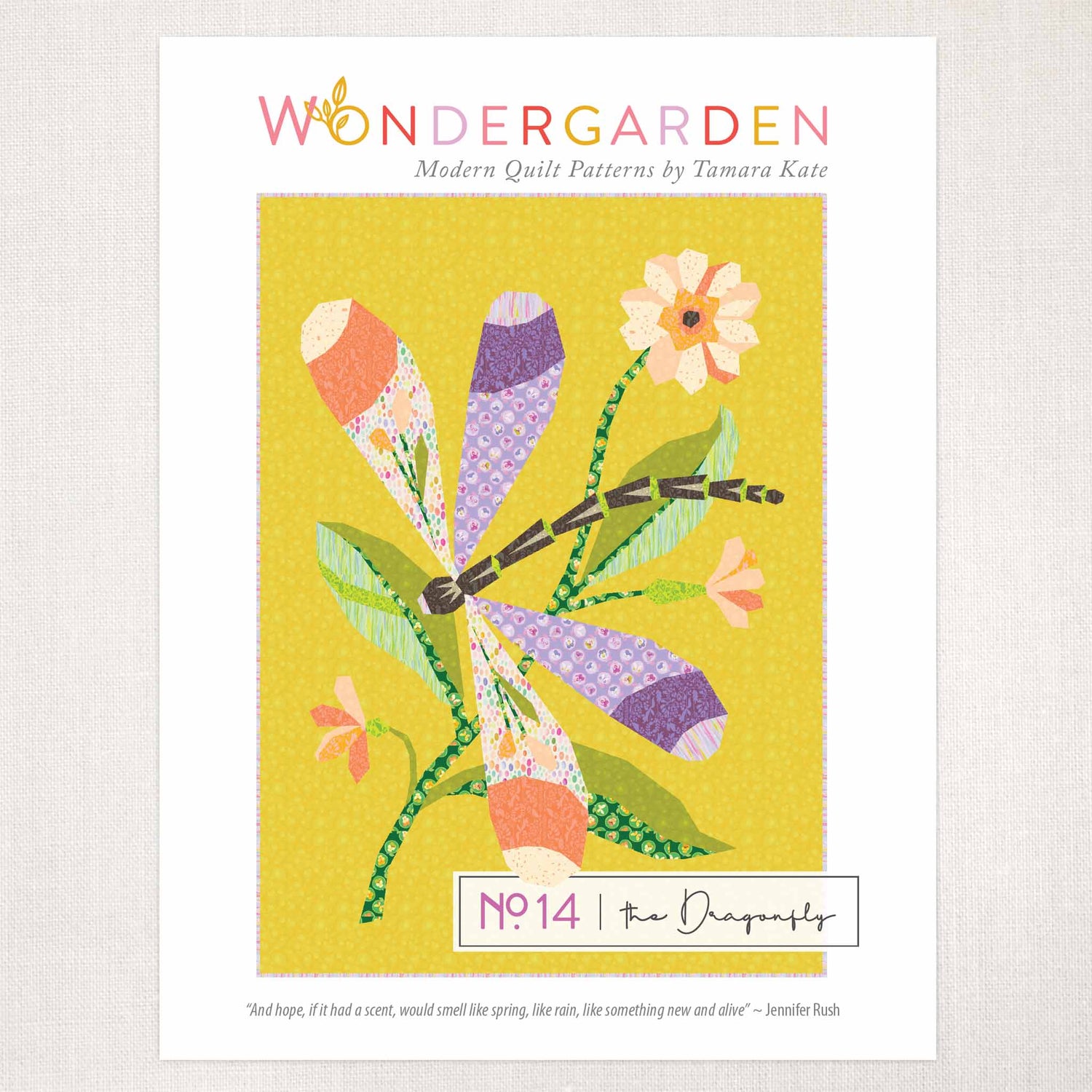 quilt pattern cover showing a large colourful dragonfly on green leaves with a flower, on a yellow ground.
