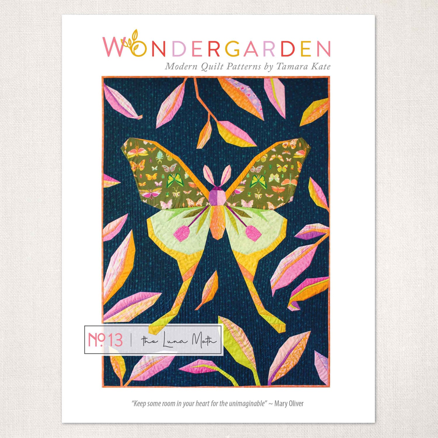 quilt pattern cover showing a large green and yellow luna moth framed by pink, yellow and purple tropical leaves on a dark ground.