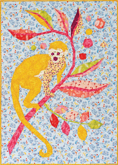 quilt of a yellow capucin monkey on a colourful branch on a light blue ground