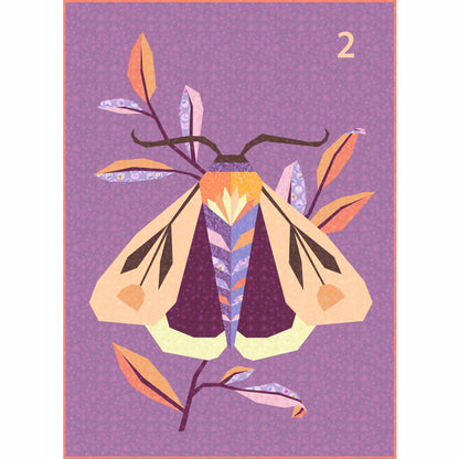 quilt of a large moth in oranges and  purples 