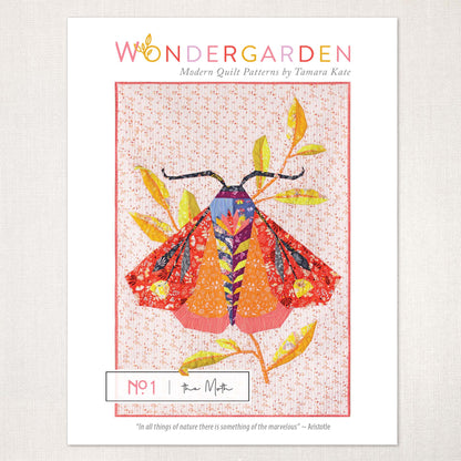 quilt pattern showing a large red and orange moth with leaves on a soft blush ground