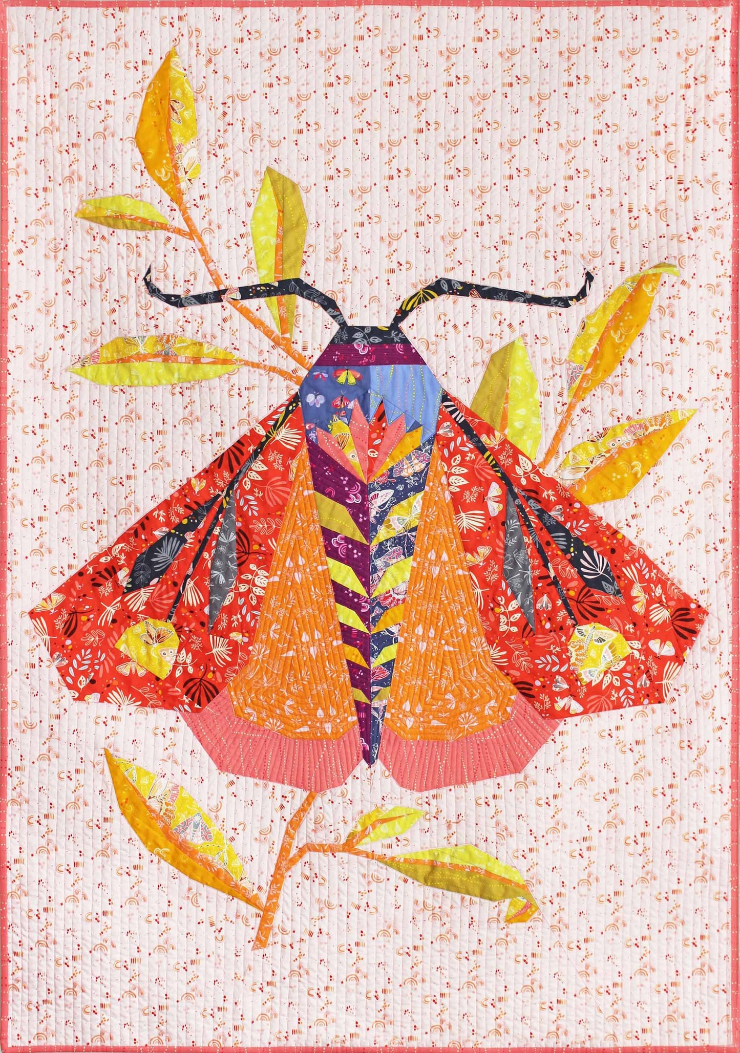 quilt of a large red and orange tiger moth on a cream ground with leaves